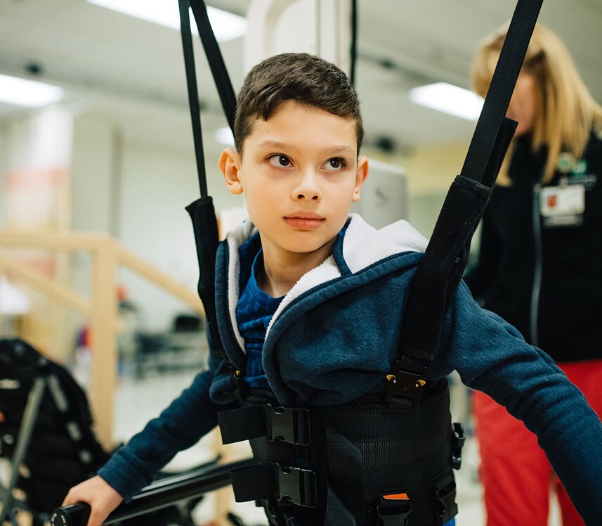 boy using robotic technology for pediatric orthopedic therapy